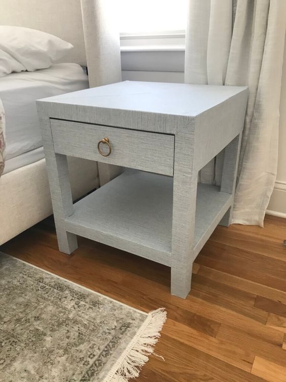 a lovely IKEA Lack table hack into a nightstand with an additional shelf, a drawer covered with grasscloth wallpaper is chic