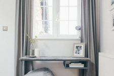 a lovely window nook with a grey Vittsjo table with a wooden tabletop, a basket with pillows and a blanket and grey curtains is amazing