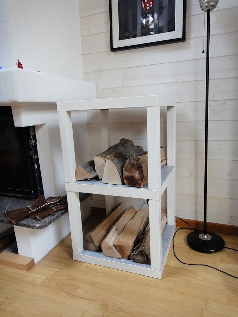 a simple and pretty IKEA Lack table hack - two pieces used to build a single firewood stand by the fireplace, which is a smart solution
