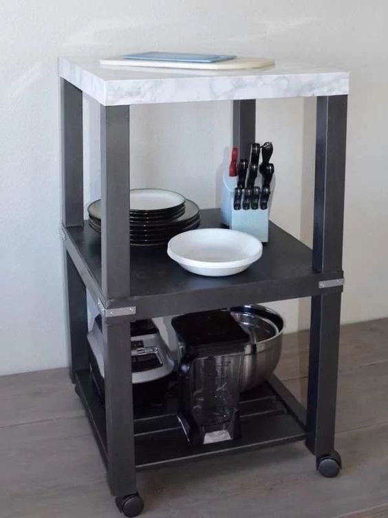 a small and mobile kitchen island of two IKEA Lack tables on casters, with a marble tabltop is a lovely idea for a small space