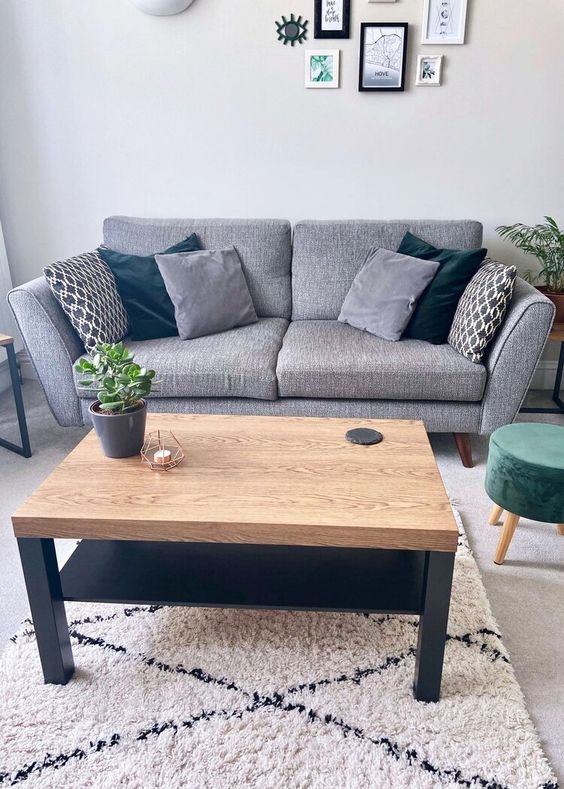 a stylish IKEA Lack table hack with a stained tabletop and black legs plus an additional shelf is a cool idea for this Scandi room