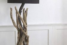 a stylish floor lamp of driftwood, with a black lampshade is a beautiful way to reuse driftwood and add a natural feel to the interior