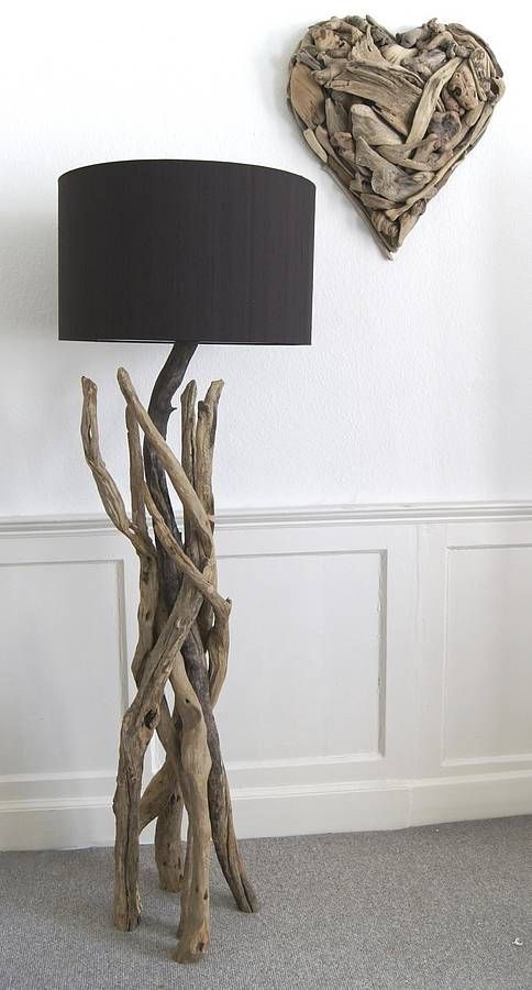 a stylish floor lamp of driftwood, with a black lampshade is a beautiful way to reuse driftwood and add a natural feel to the interior