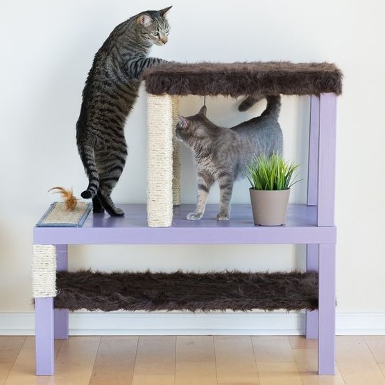 a stylish pastel cat condo made of IKEA Lack tables in lilac with scratchers and beds