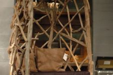 a trendy chair with a back madde of driftwood is a cool way to get a very edgy piece and reuse some materials at the same time