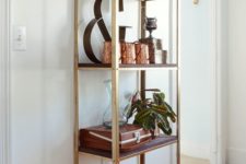 an IKEA Hyllis shelf hacked with gold paint and dark stained shelves brings a touch of rustic glam