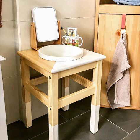 an IKEA Oddvar stool with dipped legs and a color block top as a vanity for a kids' sink