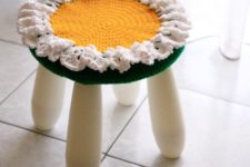 dress up an IKEA Mammut stool with a bright crochet cover that imitates a flower for a bold look