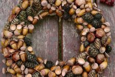 a beautiful fall woodland wreath with acorns, nuts and pinecones plus twigs is a beautiful and all-natural solution