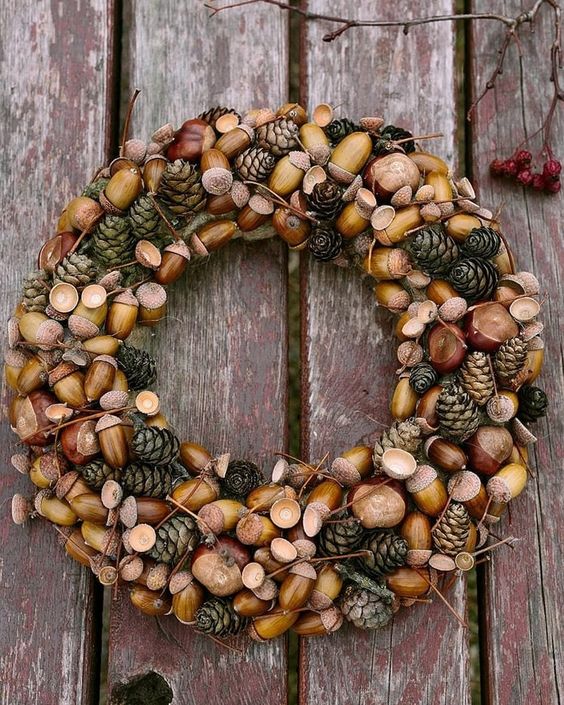 a beautiful fall woodland wreath with acorns, nuts and pinecones plus twigs is a beautiful and all natural solution