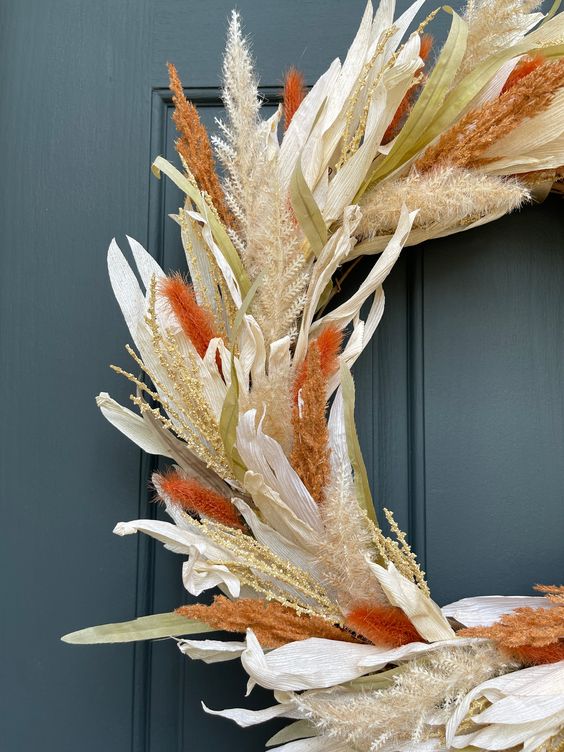 a bold fall wreath made of corn husks, wheat, leaves and bold spray painted foliage is a lovely idea to realize for decor