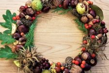 a bright fall wreath of acorns, nuts, pinecones, fruits, greenery and berries is a lovely and chic idea to rock