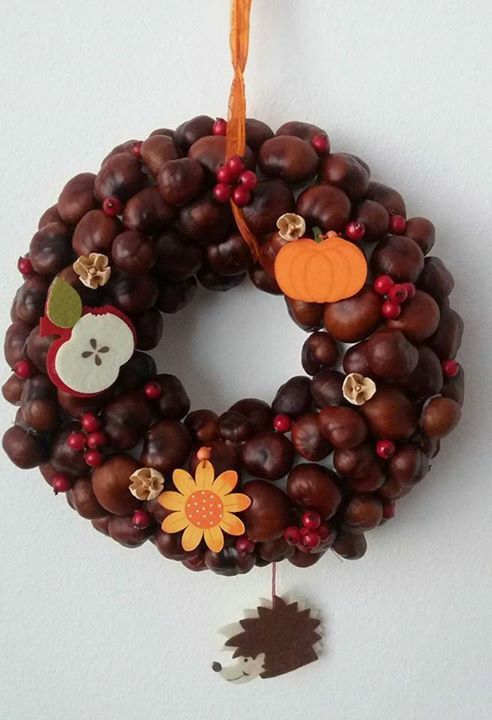a bright fall wreath of acorns, some fabric pumpkins, apples and a bloom and red berries is an amazing idea