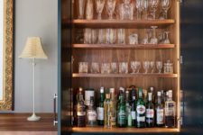 a built-in home bar with open shelves with lights and drawers for storage is a very cool idea to rock