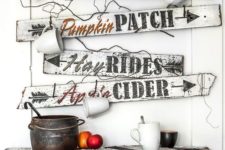 a bunch of white and black fall signs with mugs hanging on them look very relaxed and farmhouse-like