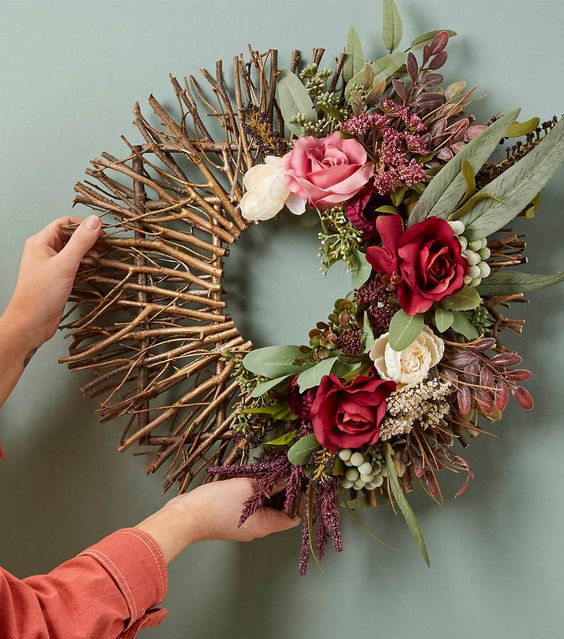 a chic fall wreath of twigs and sticks, greenery and blooms is a beautiful decoration to DIY