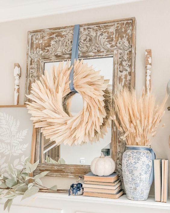 a classy and very elegant corn husk wreath with a blue ribbon is a great solution for more formal and vintage spaces