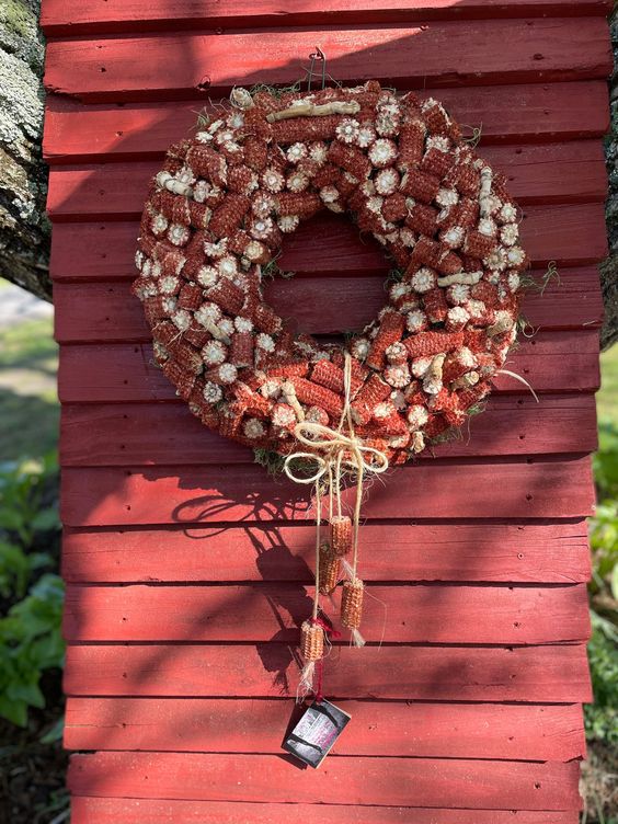 a colorful corn cob wreath with twine and additional cobs hanging down is a lovely idea for the fall