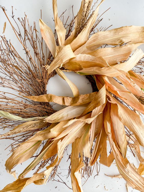 a creative twig, wheat and corn husk wreath is a fabulous idea for a fall outdoor space, it looks great