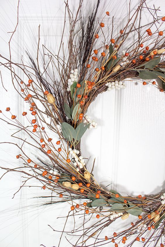 a fall twig wreath with berries, leaves, dried blooms is easy to make and it looks elegant