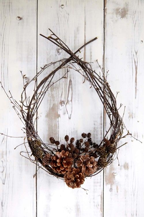 a fall twig wreath with lots of pinecones of various sizes is a gorgeous idea to rock for outdoors