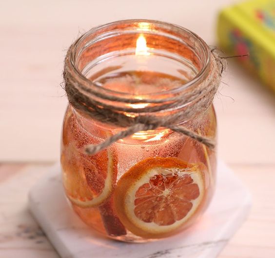 a jar with cinnamon, citrus, a floating candle is a gorgeous solution for a fall space, it will fill it with aromas