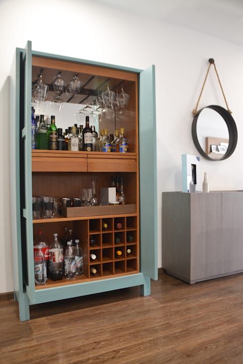 a light blue home bar cabinet with open shelves and a tray plus a mirror backsplash is a stylish idea