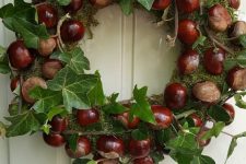 a lovely fall wreath with moss, acorns, leaves and twigs is a beautiful idea for woodland decor