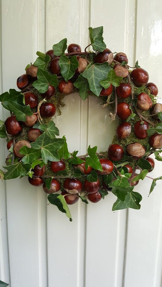 a lovely fall wreath with moss, acorns, leaves and twigs is a beautiful idea for woodland decor