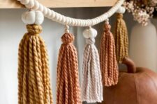 a pretty fall and Thanksgiving garland of wooden beads, felt pumpkins and bright fall-colored tassels is a great idea in fall colors