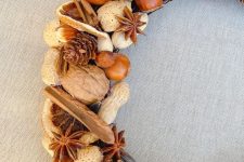 a rustic farmhouse wreath with nuts of various kinds, pinecones, cinnamon bark and lots of other stuff is a lovely harvest-inspired idea