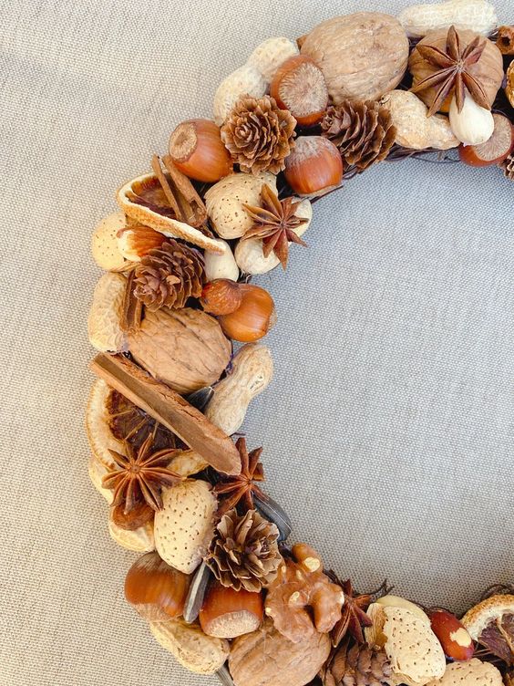 a rustic farmhouse wreath with nuts of various kinds, pinecones, cinnamon bark and lots of other stuff is a lovely harvest inspired idea