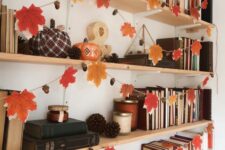 a simple and cozy fall garland of silk leaves and acorns is a stylish idea for fall and Thanksgiving, it will give a woodland feel to the space