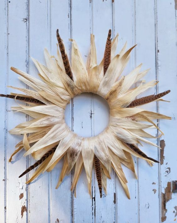 a simple corn husk wreath with a bit of feathers will give your outdoor space not just a rustic but also a boho look