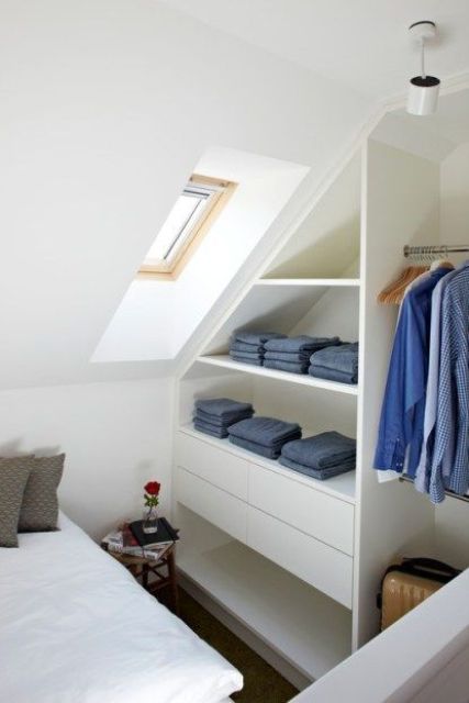 a sleek attic clothes storage item with open shelves and drawers is a stylish and comfortable idea for a small bedroom