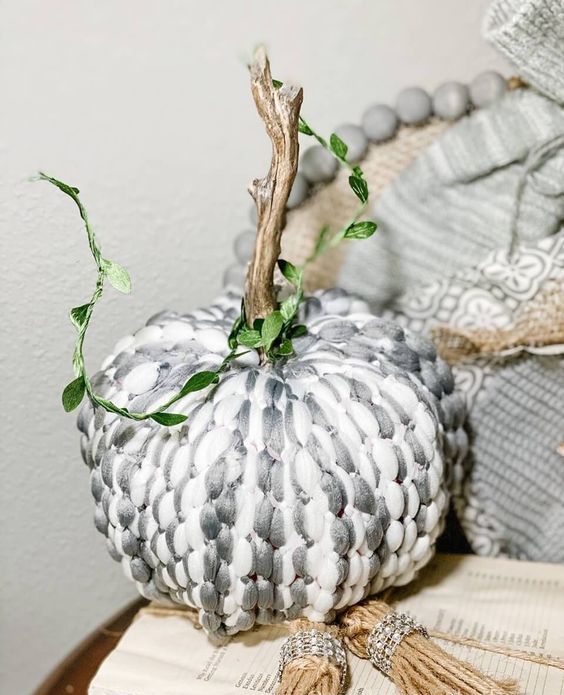 a styrofoam pumpkin covered with grey and white yarn, with a natural stem is a fantastic idea