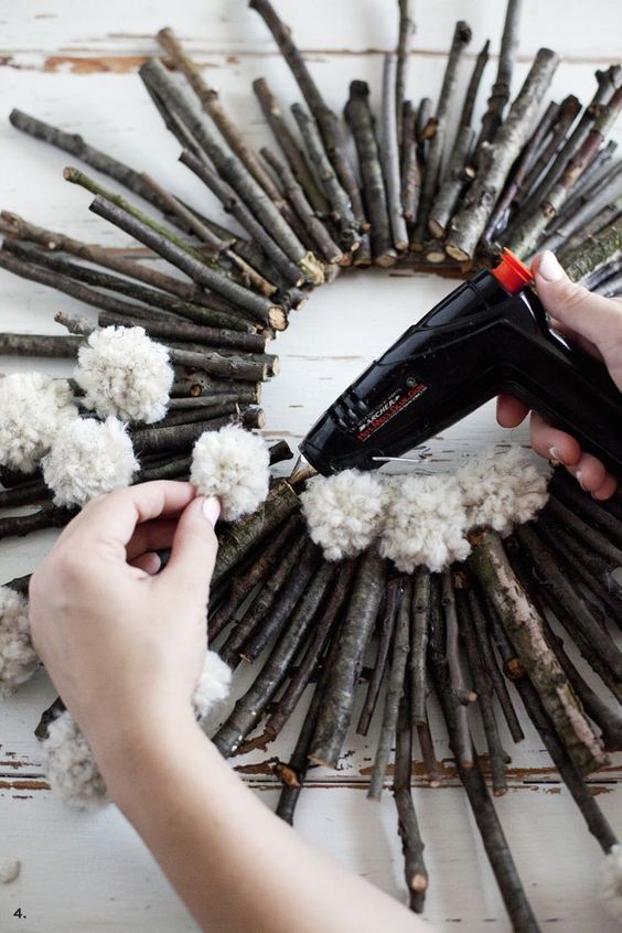 a twig and stick wreath with white pompoms is an easy and long-lasting decoration for the fall