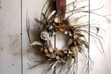 a twig fall wreath with acorns, dried leaves, nuts and gilded berries is a simple and natural idea
