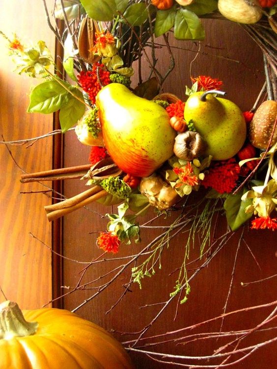a vine and twig fall wreath with faux fruits, veggies, bright blooms and greenery is a perfect solution for Thanksgiving's front door decor