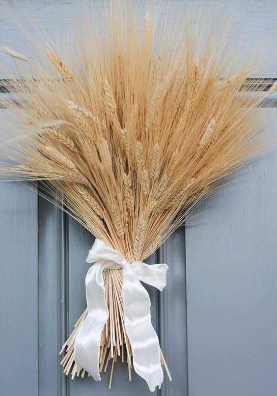 a white bundle wreath with a white silk bow is a lovely idea for accenting your front door and making it fall like