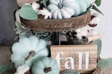 a wooden tiered tay with faux grene pumpkins, leaves, cotton and wooden signs is a lovely farmhouse decoration