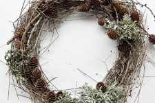 a woodland fall wreath of twigs, pinecones and pale greenery will bring a fall or winter touch to the space
