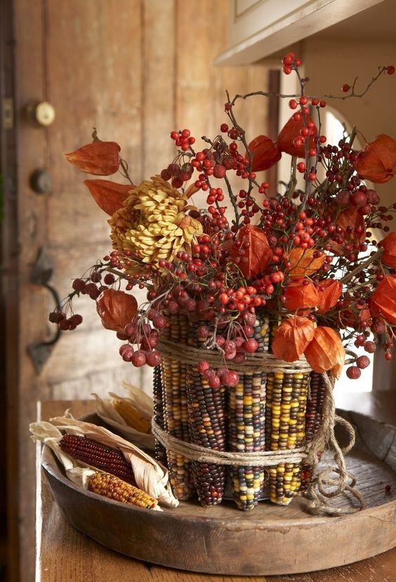 berries, dried blooms with corn cobs covering the vase is a beautiful and all-natural fall centerpiece