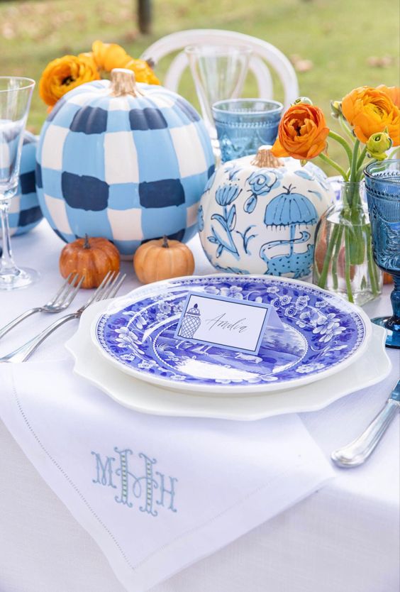 blue and white painted pumpkins to complete and a stylish blue and white fall tablescape with bright blooms