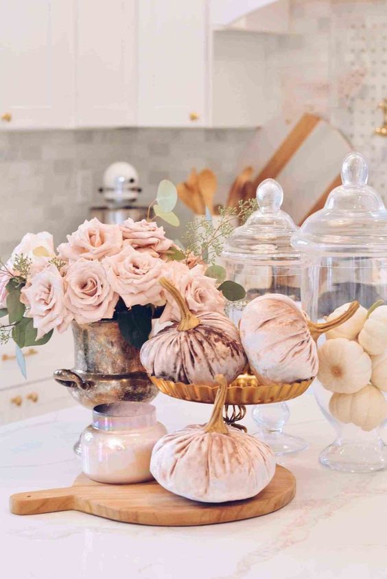 blush velvet pumpkins, a blush candle and blush roses in a vintage urn are amazing for a glam fall centerpiece
