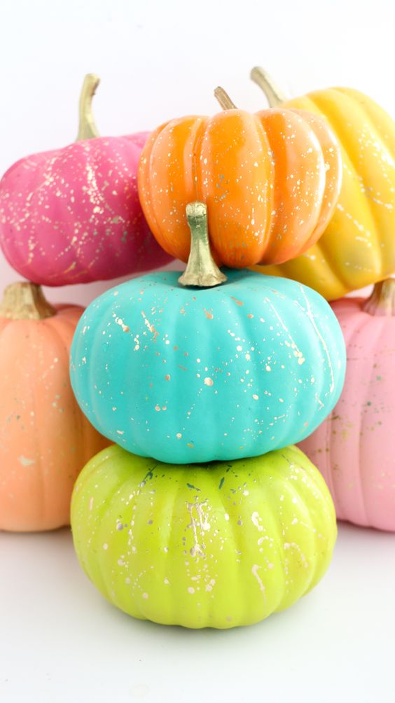 faux pumpkins painted super bright and with gold splatter are amazing and fun for colorful fall decor