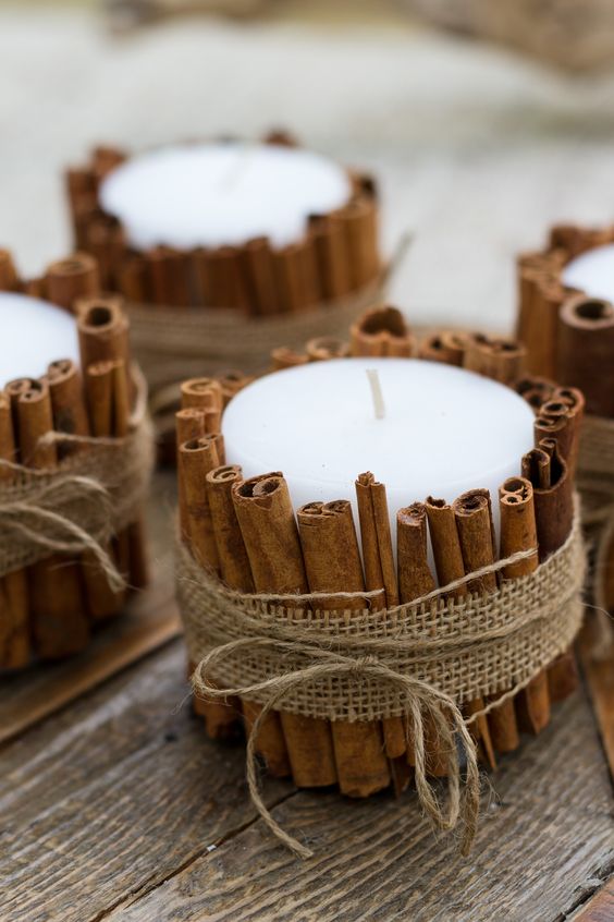 pillar candles covered with cinnamon bark and burlap will give a divine aroma to your space at once