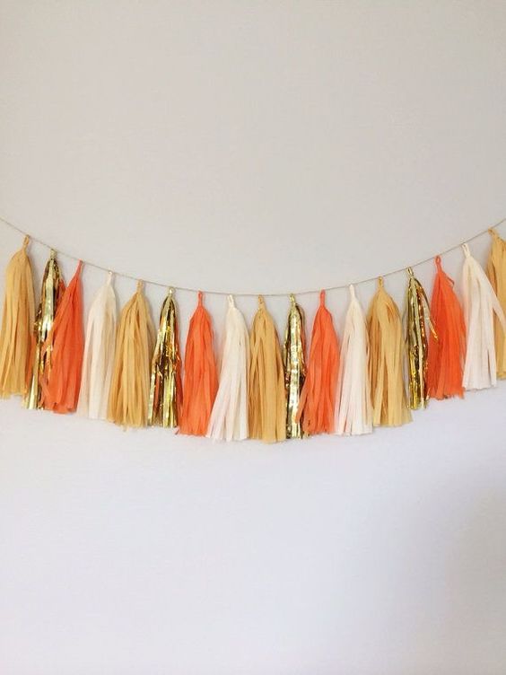 such a simple and bright tassel garland in fall colors is a lovely idea for fall and Thanksgiving, it looks chic