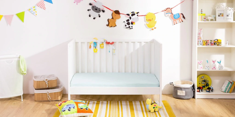 a colorful nursery with a Sundvik crib, bright animal garlands, toys, a storage unit and baskets