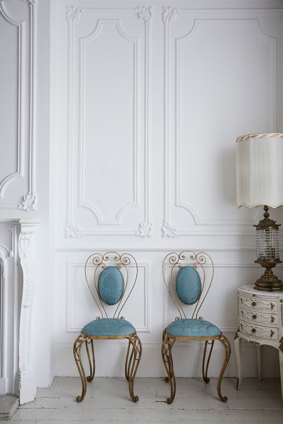 a couple of gorgeous blue antique chairs and a matching round storage table plus a vintage crystal lamp